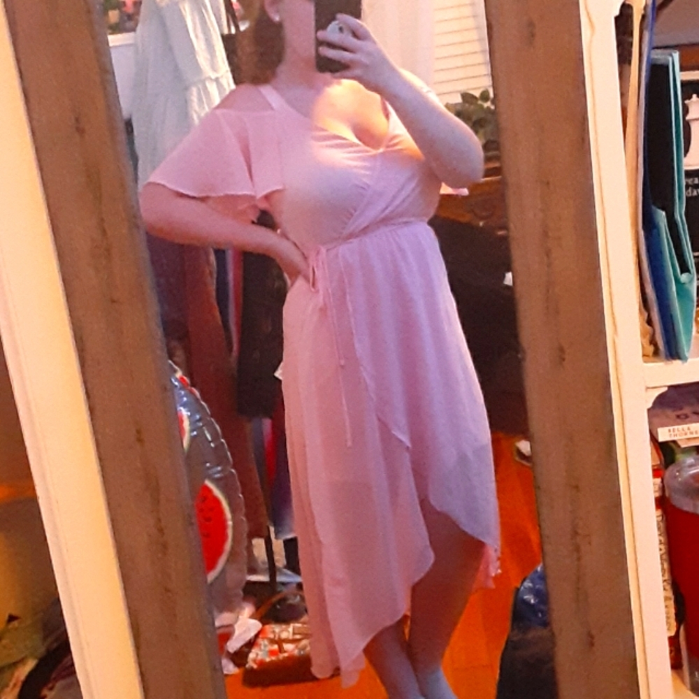 Pink dress, low in front long in the back, V neck